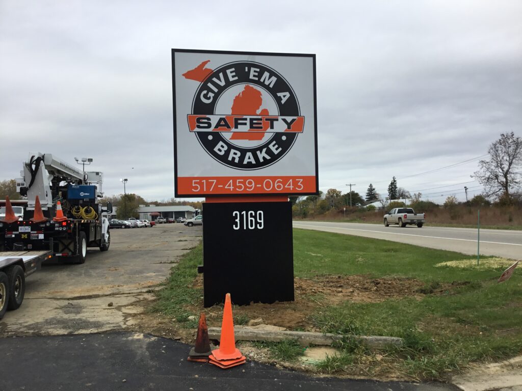 Give Em A Brake Safety pylon sign in Jackson, MI