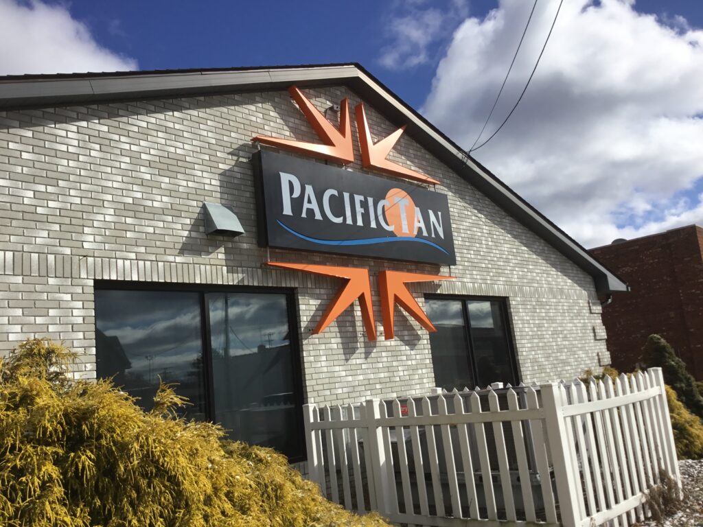 Pacific Tan wall sign in Jackson, MI