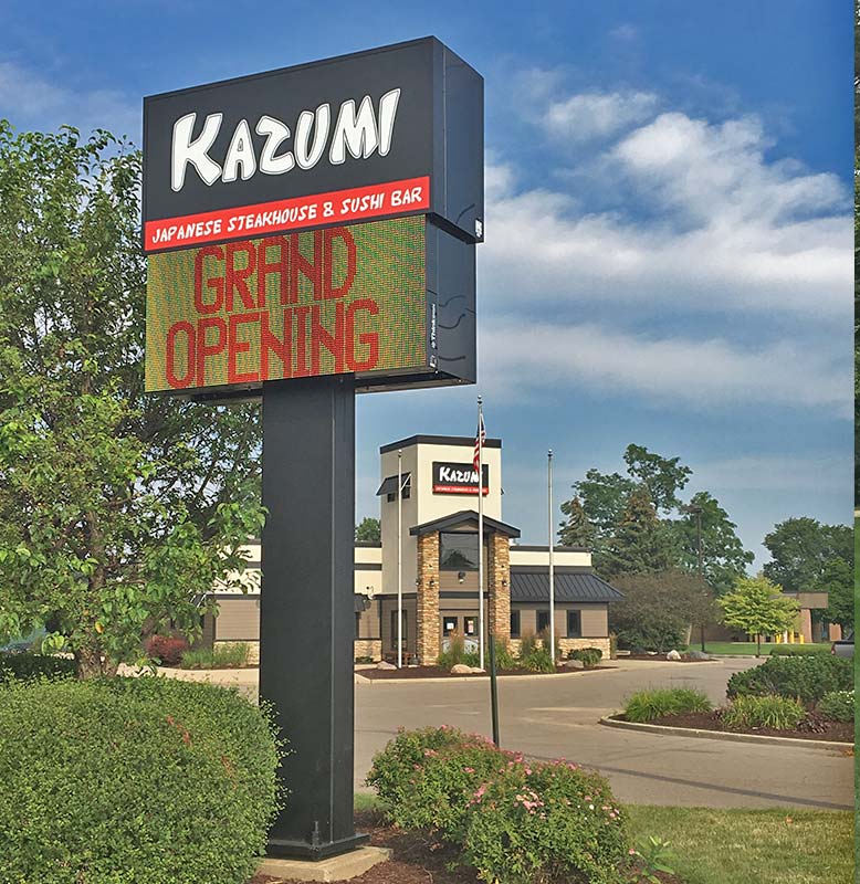 Kazumi Japanese Steakhouse & Sushi Bar pylon sign with electronic message center in Holt, MI