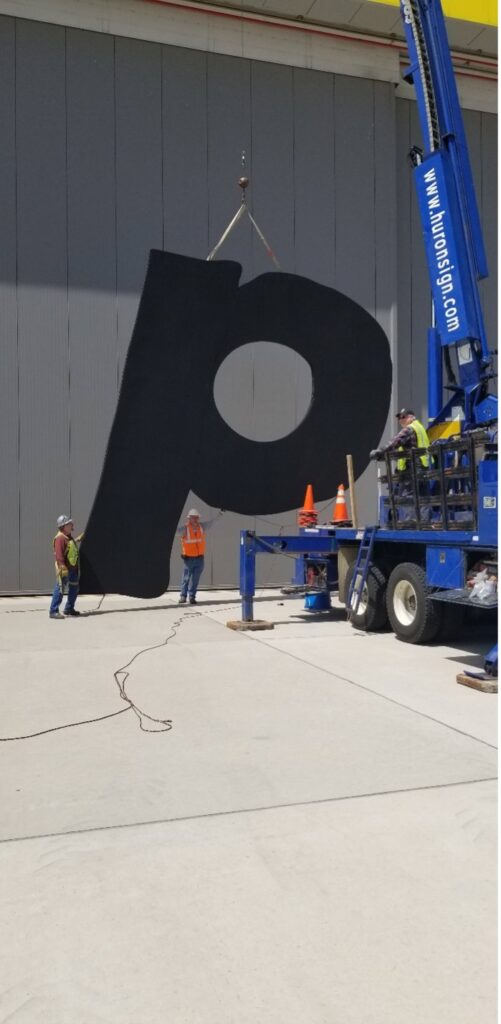 Removing wall letters in 2022 for updated logo in Detroit, MI