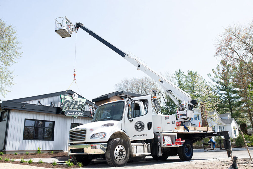 Johnson Sign Company Truck Installing Otto's Sign